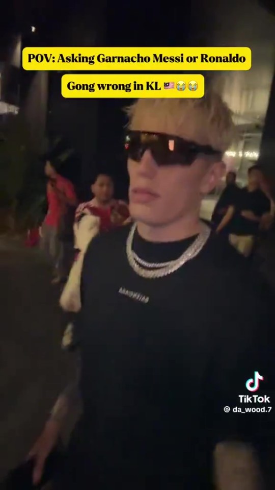 Person wearing sunglasses walking at night, text overlay says "POV: Asking Garnacho Messi or Ronaldo Gong wrong in KL".