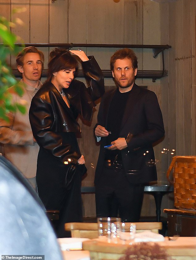 Their brothers were also present - Dakota's brother Jesse attended, L, as did Swift's sibling Austin, R
