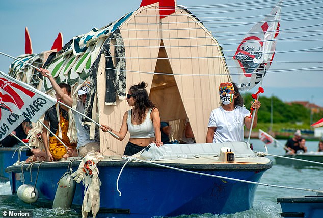 The organization is a self-described 'anti-fascist, anti-capitalist, anti-racist and trans-feminist political space' (pictured protesting against large cruise ships in Venice Lagoon)