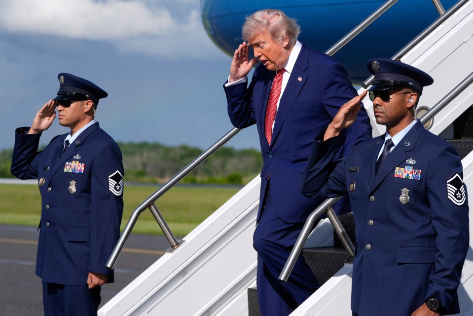 President Trump disembarking Air Force One, saluting airmen.
