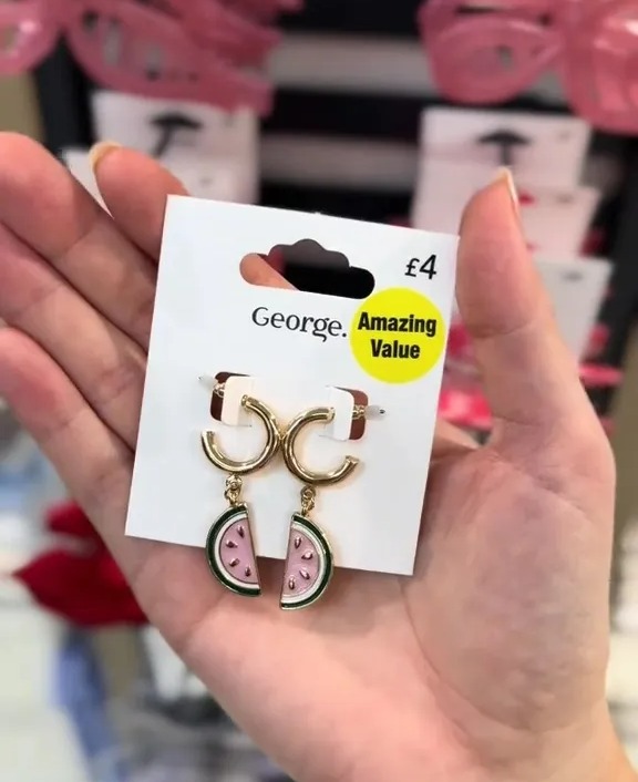 Watermelon slice earrings on a store display card.