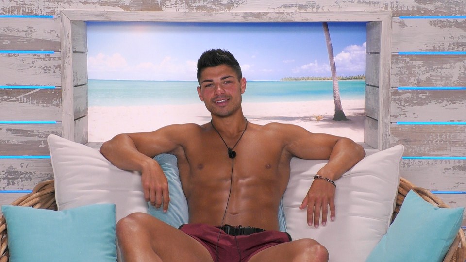 Anton from Love Island sitting on a couch.