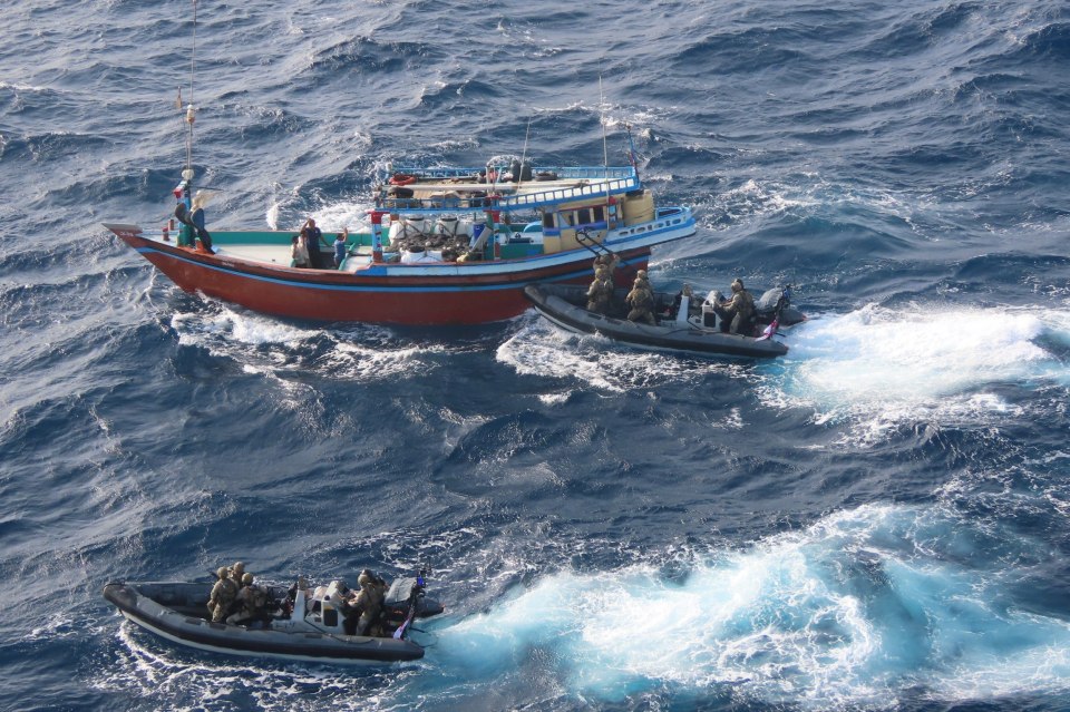 Royal Navy seizing drugs from a dhow in the Middle East.
