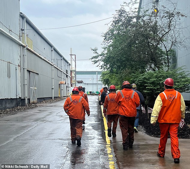 A group of steelworkers arrives at President Donald Trump's event in West Mifflin, Pennsylvania on Friday after the president backed a 'partnership' between the Pittsburgh-based U.S. Steel and Japan's Nippon