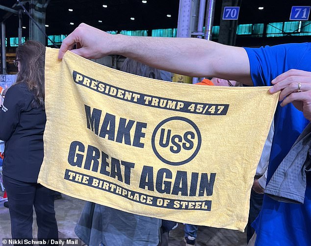 An attendee at President Donald Trump's steel deal event Friday in West Mifflin shows off a special 'Terrible Towel' being sold for $20 outside the venue to mark the occasion. Terrible Towels are a fixture at Pittsburgh Steelers games