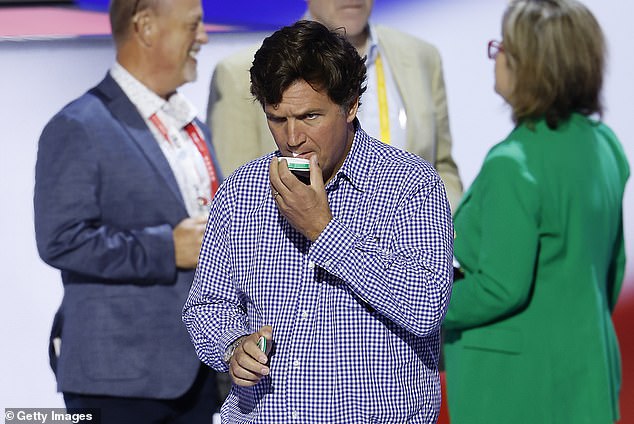 Tucker Carlson slips a Zyn into his mouth at the Republican National Convention last July