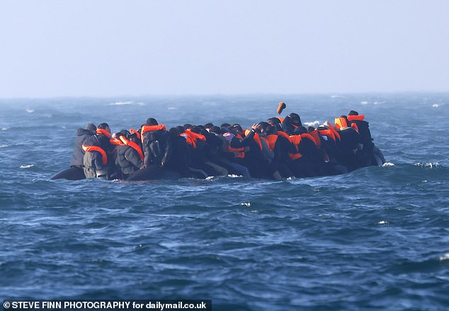 A packed dinghy full of migrants seen on the English Channel approaching the UK