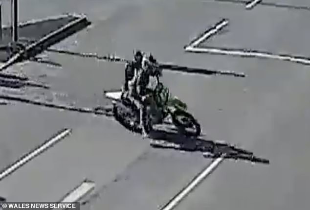 Sergeant Tom Brookes held onto the back of the bike with Scott Ryall speeding along the road