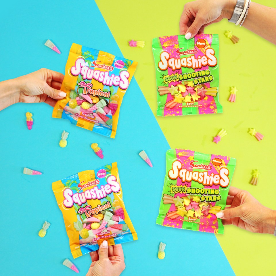 Hands holding bags of Swizzels Squashies candy; tropical fruit and sour shooting stars.