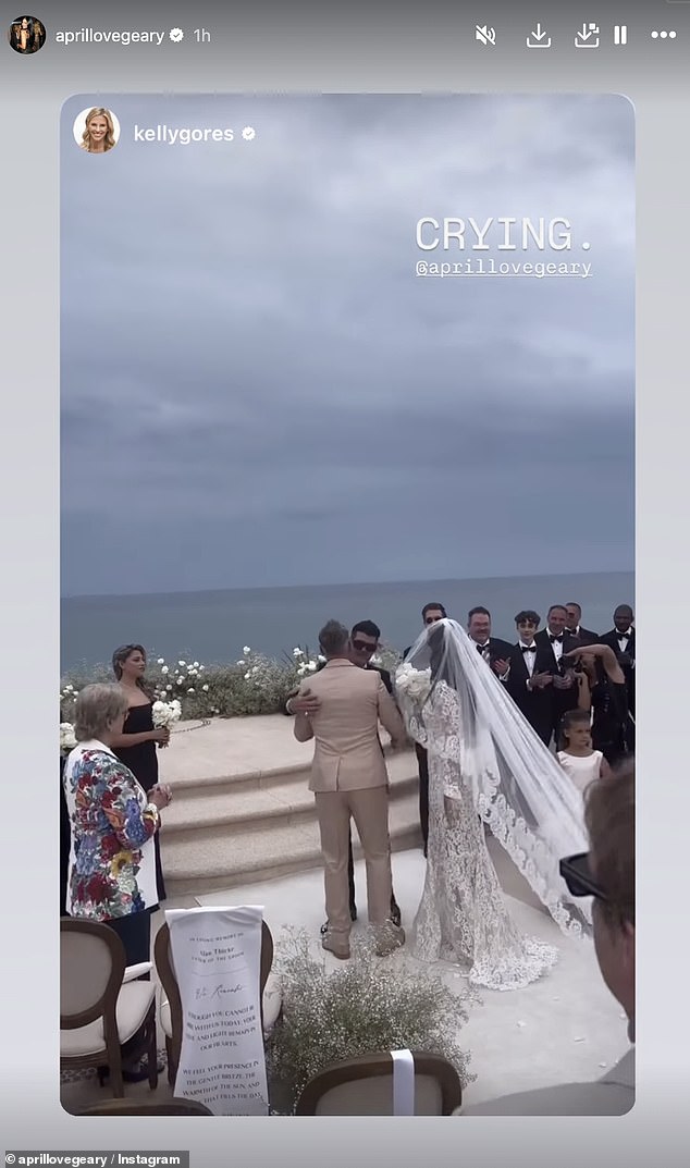 April donned a long ruffled veil and carried a bouquet of white roses