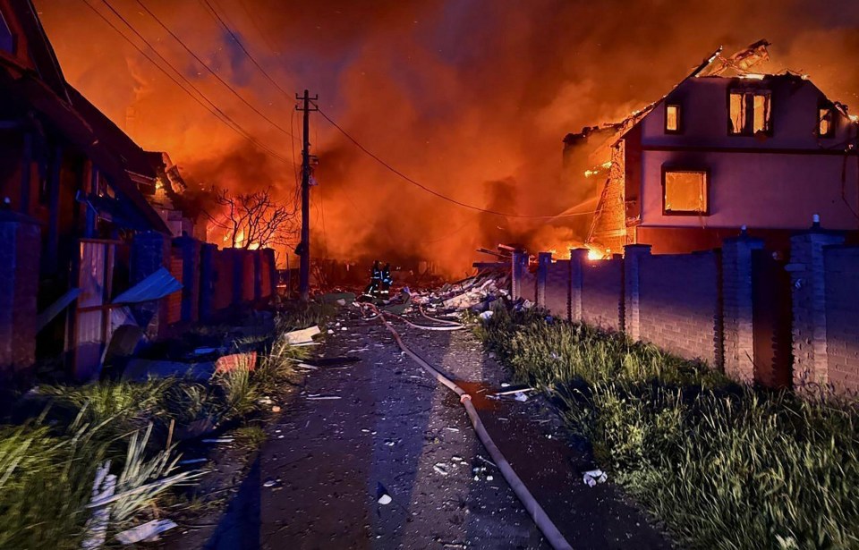 Firefighters battling a fire in a residential area after a Russian strike in Kyiv.