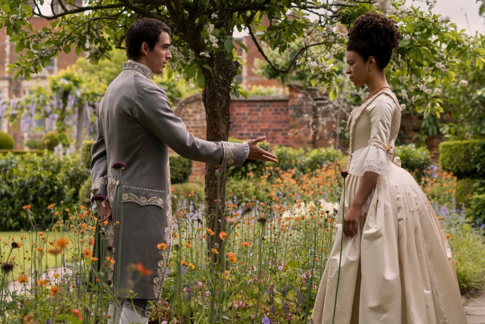 Young King George and Young Queen Charlotte in a garden.