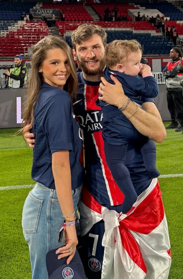 PARIS, FRANCE - MAY 17: Khvicha Kvaratskhelia of PSG, his wife Nitsa Tavadze and their son Damiane Kvaratskhelia celebrate after the Ligue 1 trophy ceremony following the Ligue 1 football match between Paris Saint-Germain (PSG) and AJ Auxerre (AJA) at Parc des Princes stadium on May 17, 2025 in Paris, France. (Photo by Jean Catuffe/Getty Images)