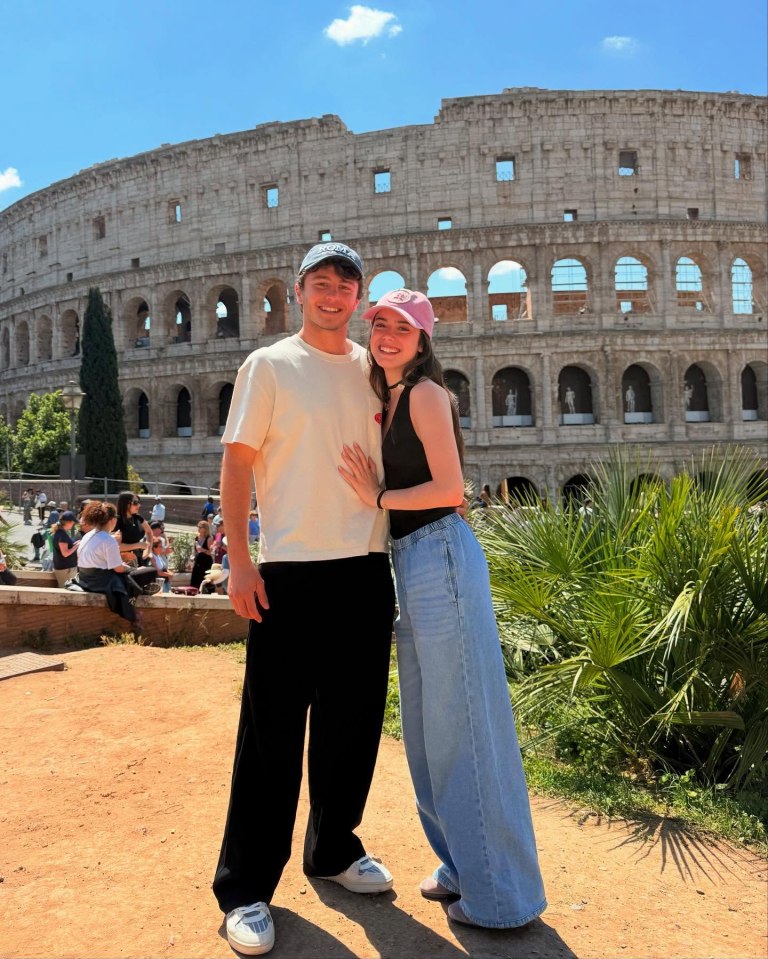 Couple posing in front of the Colosseum.