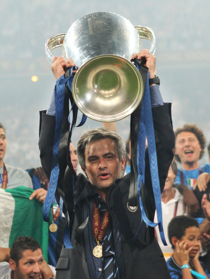 José Mourinho holding the Champions League trophy after Inter Milan's victory.