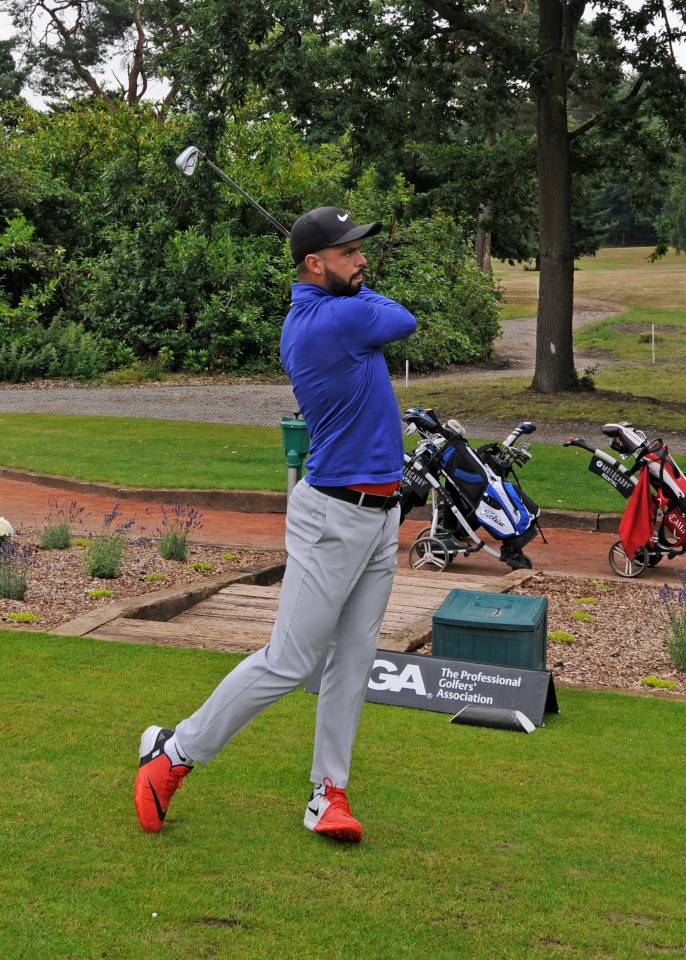 Golfer taking a swing on a golf course.