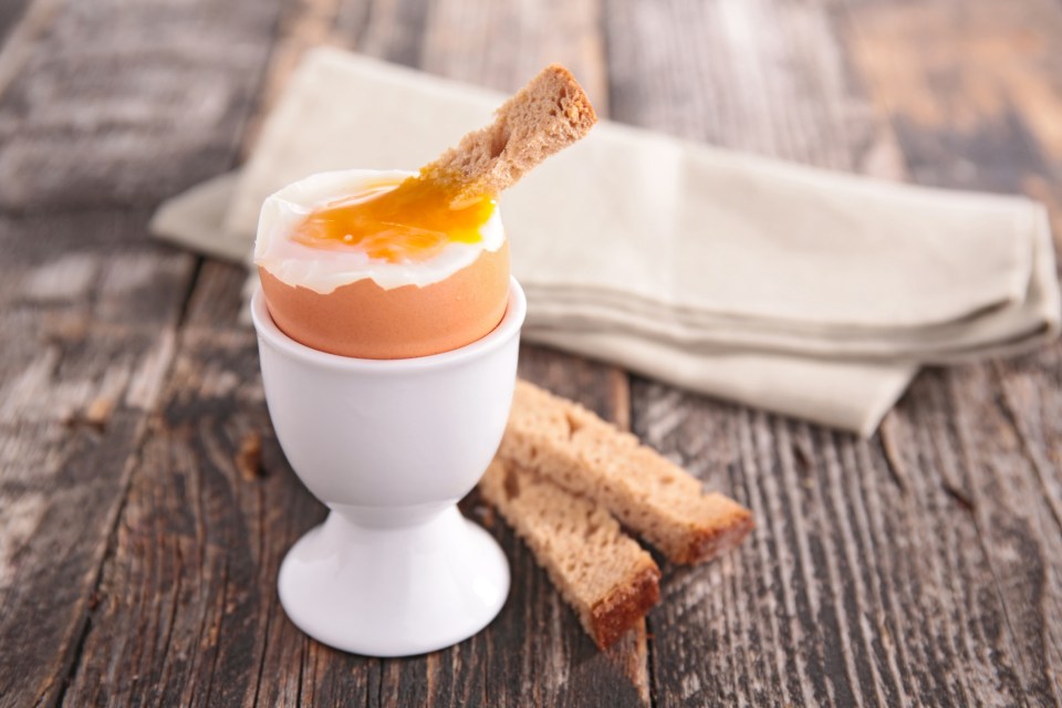 Soft-boiled egg in an egg cup with toast.