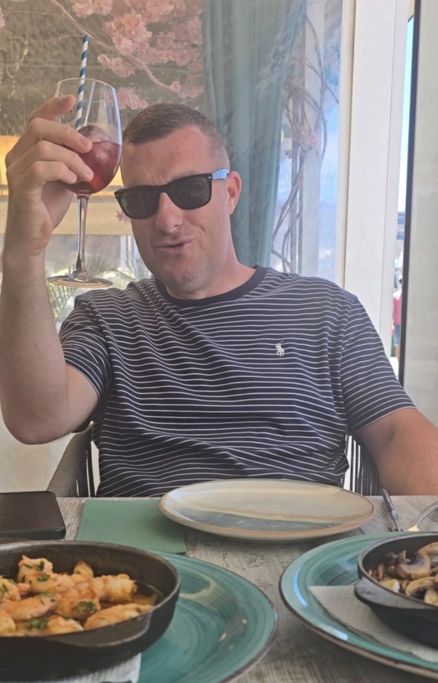 Man holding a drink in a restaurant.