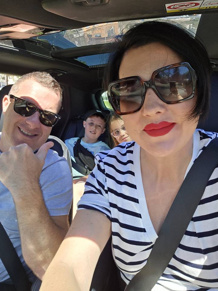 Family selfie in a car.