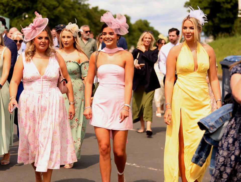 Racegoers in summer dresses and hats.
