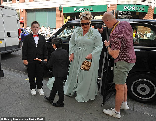 Gemma looked glamorous in a teal gown as she stepped out of her taxi for the big day (also pictured Claire Sweeney's son Jaxon)