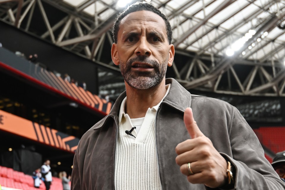 Rio Ferdinand giving a thumbs up at a soccer game.