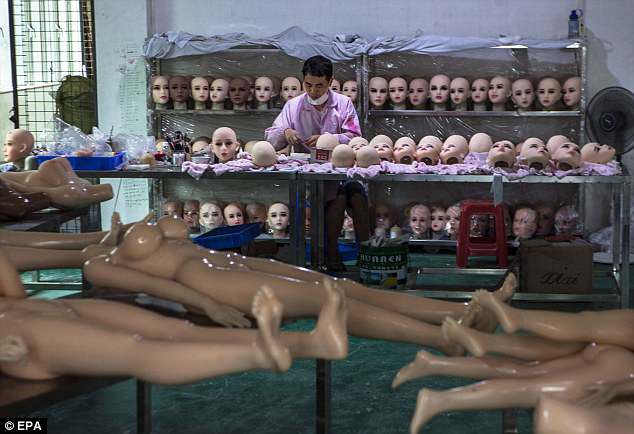 Spanish customers prefer robots with darker skin, full lips and larger genitals. Around 70 per cent of these customers also like hair on genitals. Pictured is a worker assembling sex dolls