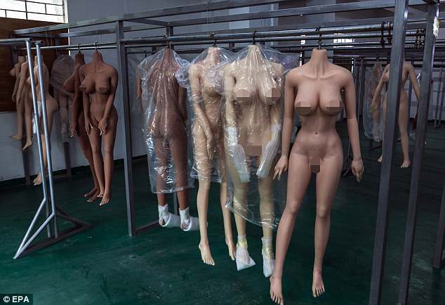 Pictured are bodies of the 'smart' sex dolls hanging to dry in dolls factory in Dongguan, Guandong Province