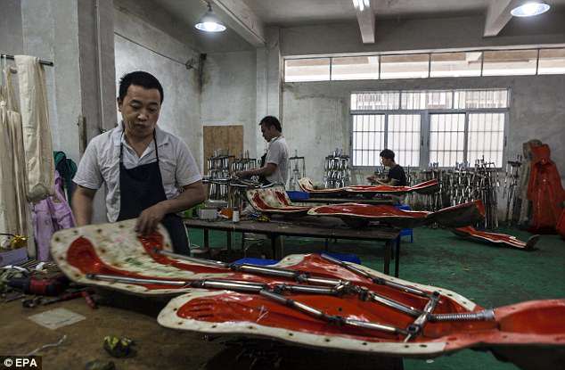 A man, pictured, assembles stainless steel skeleton for a sex doll in the mould in dolls factory in Donggua