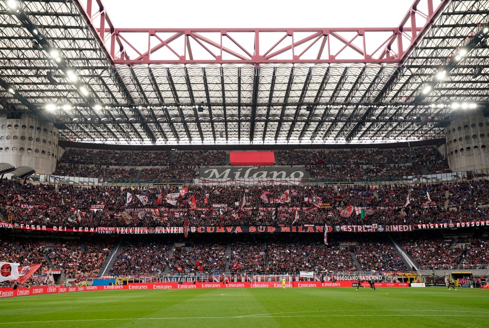 Interior view of the San Siro stadium in Milan, filled with spectators.