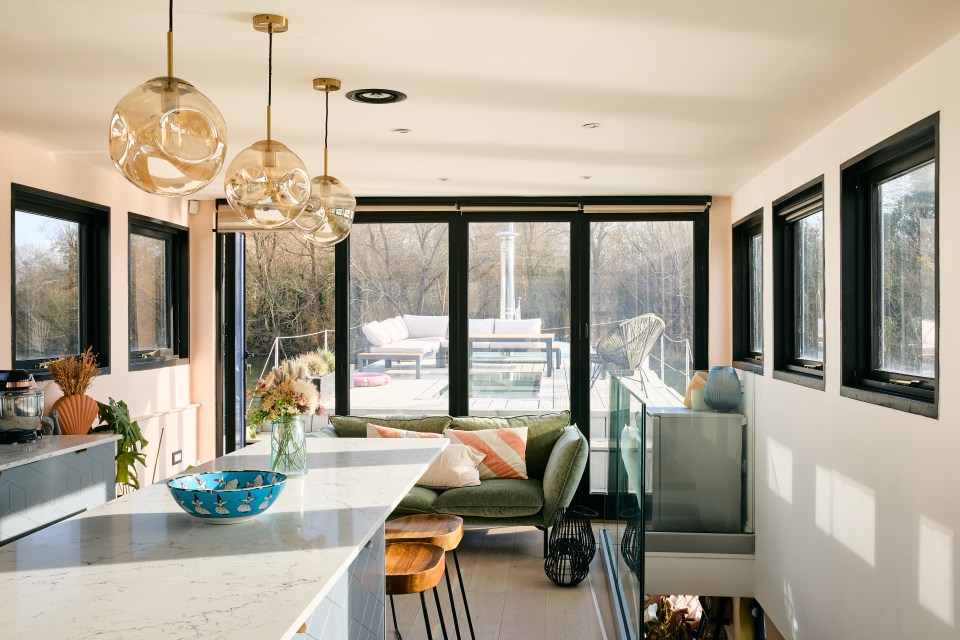 Converted houseboat for sale, moored at a marina.