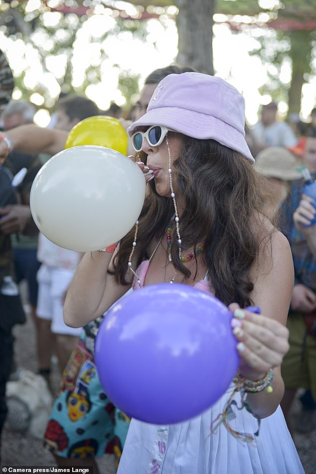 The insider warned drug-taking was widespread (Pictured: A festivalgoer with nitrous oxide balloons)