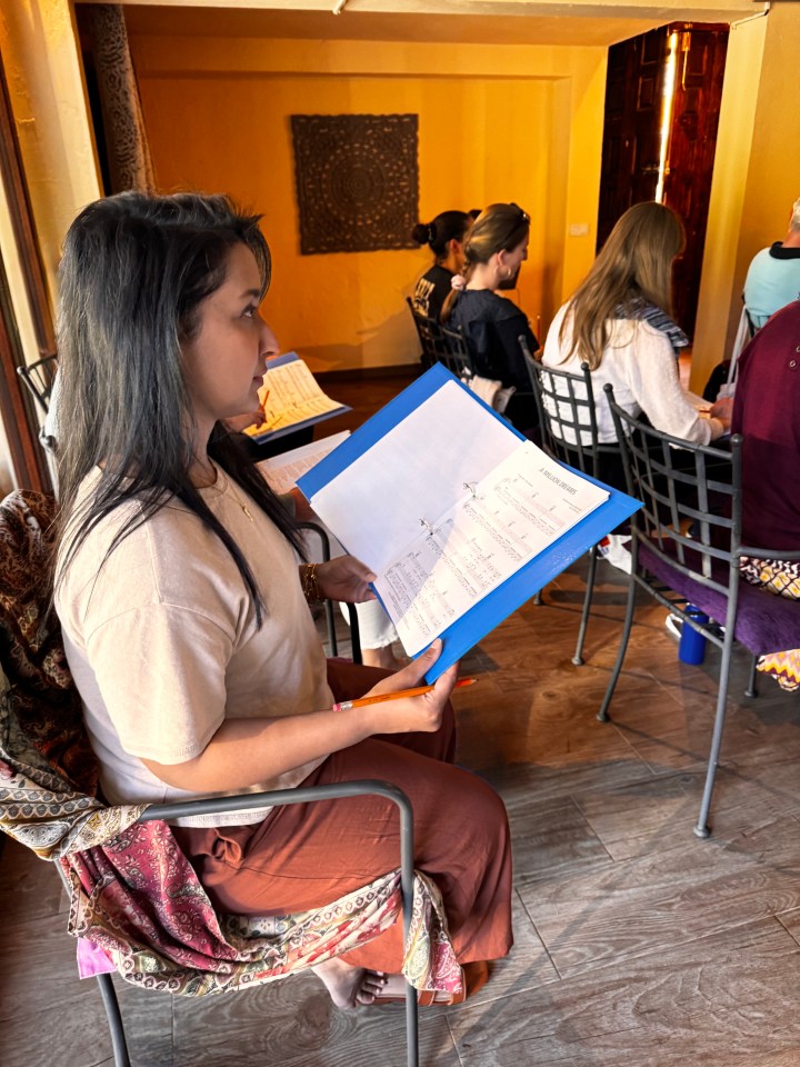 A woman reviewing sheet music.