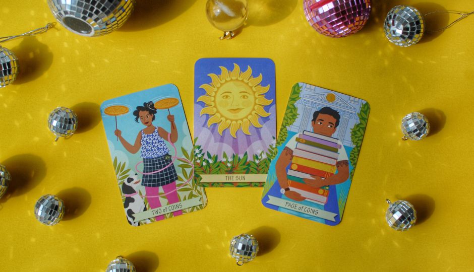 Illustration of three tarot cards surrounded by disco balls on a yellow background.  The cards show The Sun, Two of Coins, and Page of Coins.