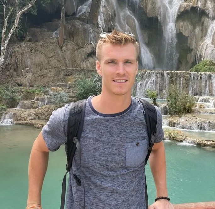 Man in front of a waterfall.