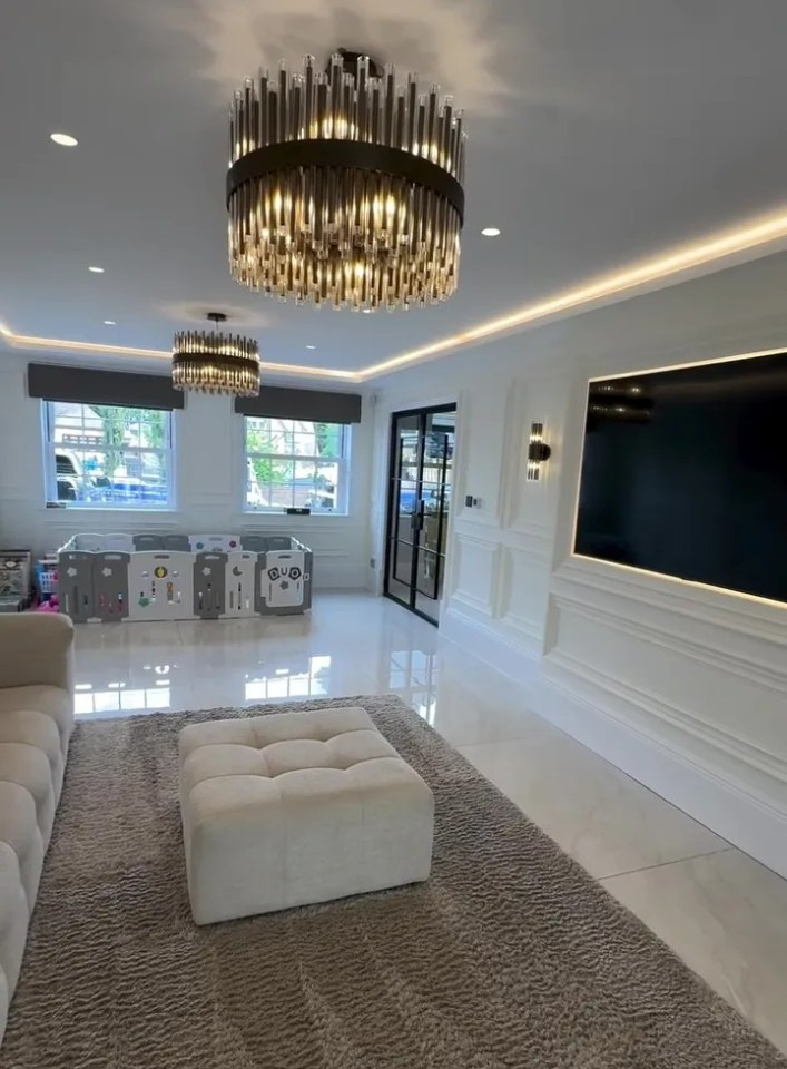 Playroom with large TV and plush rug.