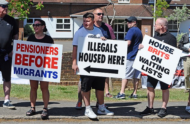 Anti-immigration protesters held up signs outside the hotel in Aldershot, which read: 'Pensioners before migrants', as well as other placards
