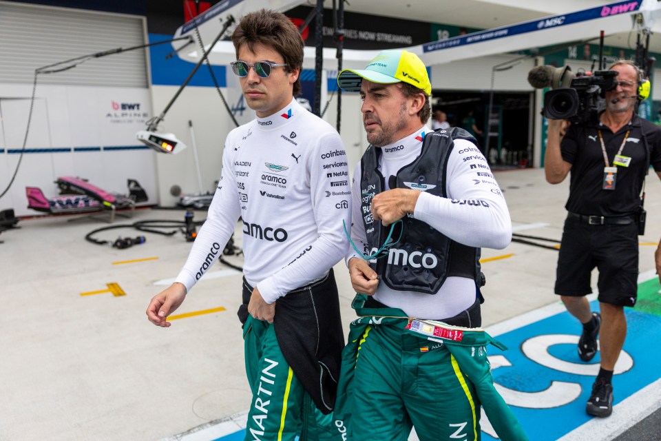 Fernando Alonso and Lance Stroll walking to the grid before a Formula 1 race.