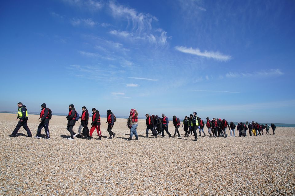 Migrants brought ashore in Dungeness, Kent, after a Channel crossing.