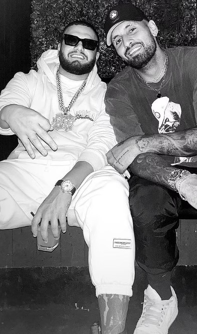 Black and white photo of Nick Kyrgios with a rapper.