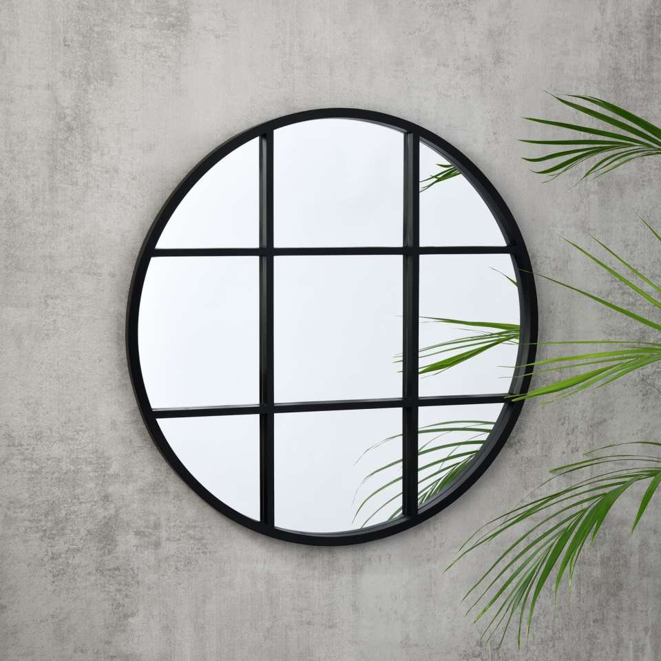 Round mirror with black grid frame.