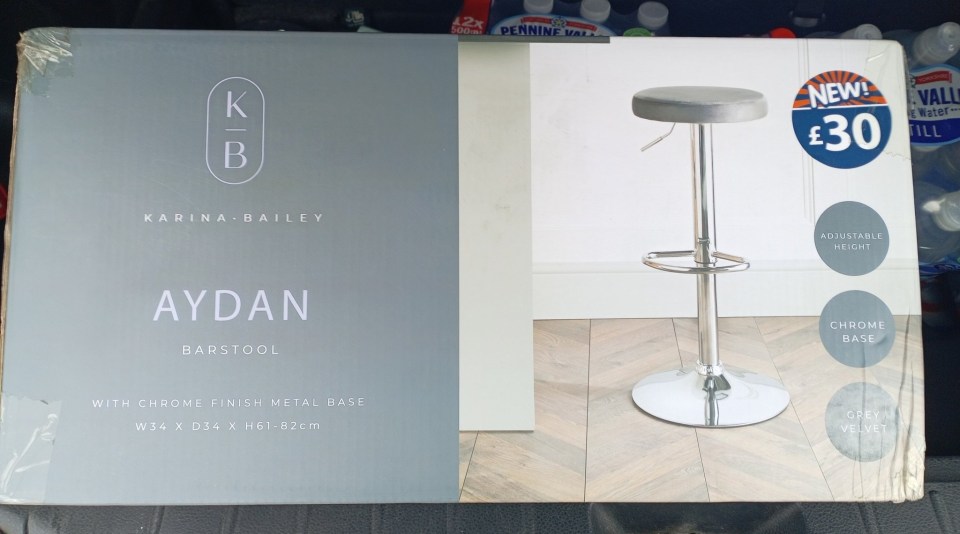 Box showing a grey velvet barstool with a chrome base; adjustable height.