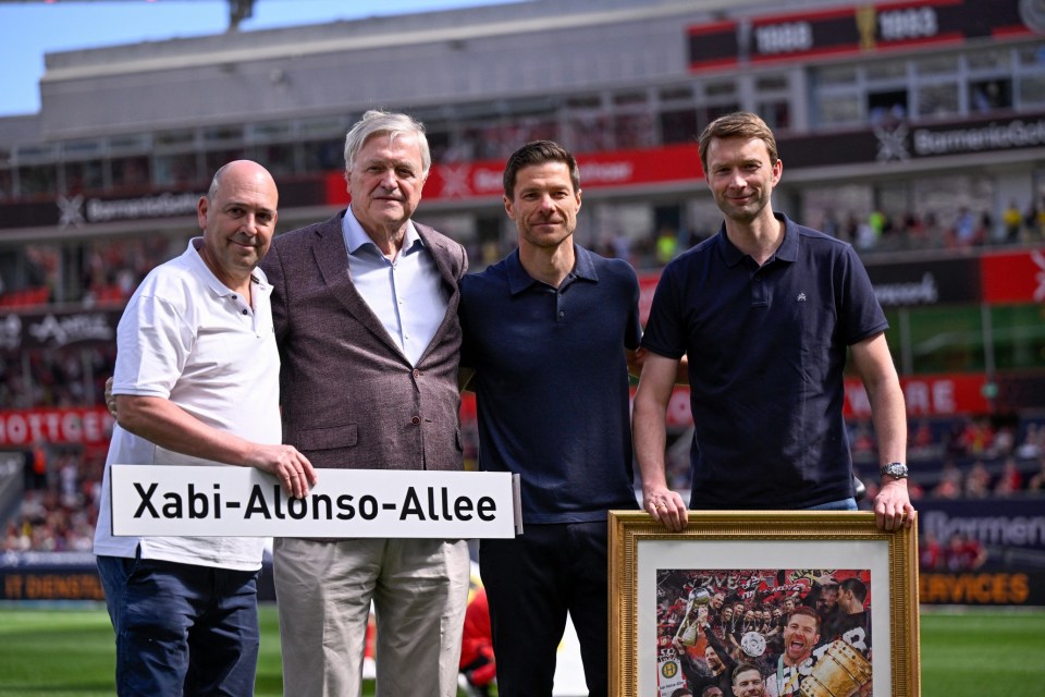 (L-R) Bayer Leverkusen's CEO Fernando Carro, Werner Wenning, Chairman of the Shareholders' Committee, Bayer Leverkusen's Spanish head coach Xabi Alonso and Simon Rolfes, managing director of sport pose for a photo during the event marking Alonso's last home match prior to the German first division Bundesliga football match between Bayer 04 Leverkusen and Borussia Dortmund in Leverkusen, western Germany, on May 11, 2025. Bayer Leverkusen coach Xabi Alonso announced on May 9th he will leave the club at the end of the season, amid reports linking him to Spanish giants Real Madrid. Alonso said it was "the right moment" to announce the exit, but did not confirm his next post, saying it was "not the right moment to talk too much about the future". (Photo by INA FASSBENDER / AFP) / DFL REGULATIONS PROHIBIT ANY USE OF PHOTOGRAPHS AS IMAGE SEQUENCES AND/OR QUASI-VIDEO (Photo by INA FASSBENDER/AFP via Getty Images)