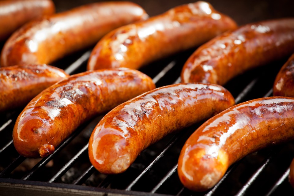 Sausages grilling on a barbecue.