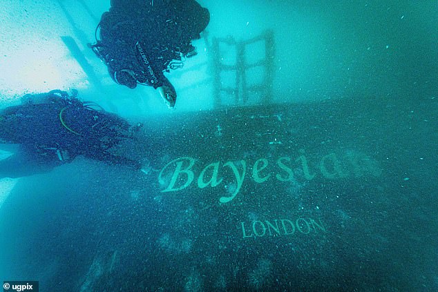 Clearly visible in the gloom 150ft below the surface of the sea, gold lettering marks out the name of the doomed Bayesian super-yacht