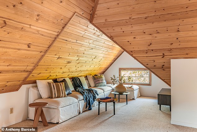 Upper attic lounge space with vaulted wood-paneled ceiling