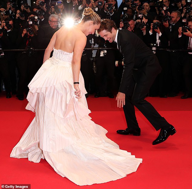 It's film's most glamorous event, but even the world's biggest stars suffer wardrobe malfunctions (pictured: Robert Pattinson accidentally stepping on Jennifer Lawrence's dress at Cannes Film Festival 2025)