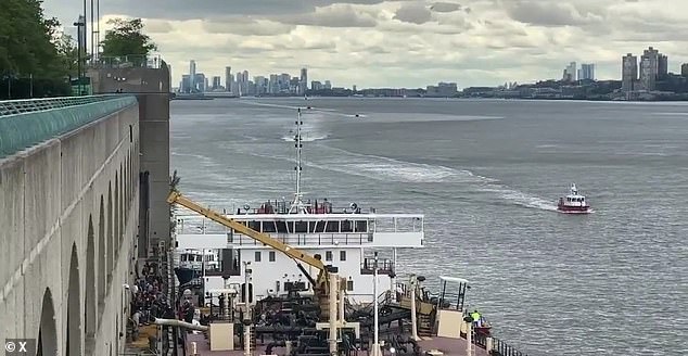 One worker is fighting for life and another being rescued from the Hudson River after an explosion on a barge