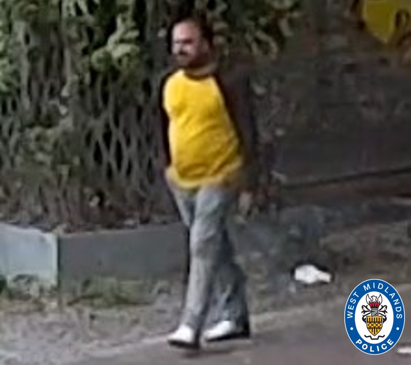 Surveillance image of a man walking, wearing a yellow shirt and gray pants.