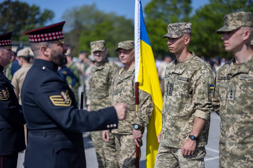 Military personnel in uniform rehearsing for a parade.